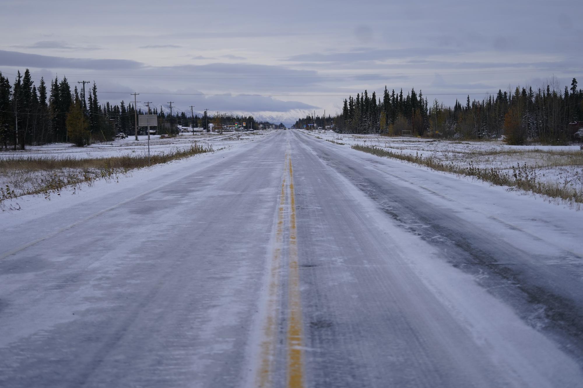 Ice and snow covers the Alaska Highway Wednesday, Sept. 22, 2021, in Tok, Alaska. The state is experiencing one of the sharpest rises in COVID-19 cases in the country, coupled with a limited statewide healthcare system that is almost entirely reliant on Anchorage hospitals. (AP Photo/Rick Bowmer)
